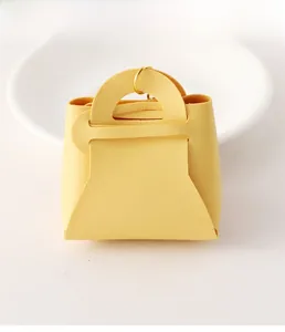 Detail showing bright yellow lychee texture leather coin purse with golden metal ring clip