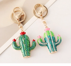 Detail of handmade cactus keychains with sparkling crystals and gold-plated alloy