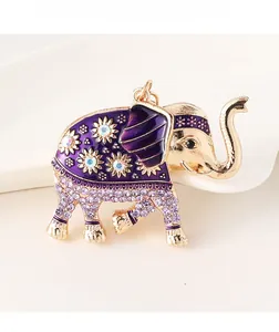 Detail of colorful elephant keychain with purple enamel, crystals, and golden alloy base