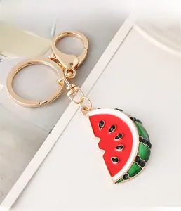 Detailed view of rhinestone watermelon keychain with gold alloy clasp and red enamel finish