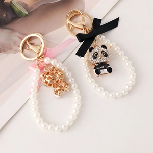 Cartoon panda pearl keychain with silk bow and gold clasp for bags and accessories