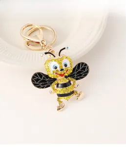 Detailed close-up of a creative bee keychain with sparkling yellow and white rhinestones