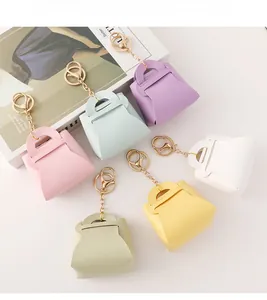 Close-up of colorful leather mini coin purse keychains with gold metal lobster clasps