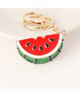 Close-up of watermelon keychain with red enamel and sparkling green rhinestones