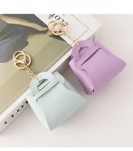 Detail of mini leather coin purses with litchi texture in green and purple pastel colors