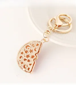 Detail of gold metal keychain with a hollowed-out crescent moon and star pendant