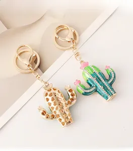 Detail of cactus keychain featuring green enamel, sparkling crystals and gold heart charm