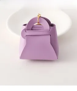Detail view of purple lychee grain PU leather coin purse charm with gold metal clasp hook