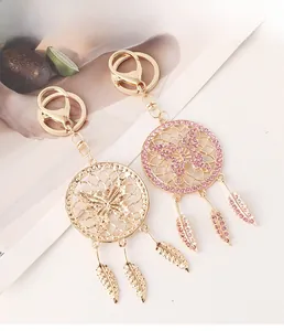 Detailed view of hollow dreamcatcher butterfly keychains with pink rhinestones and metal feathers