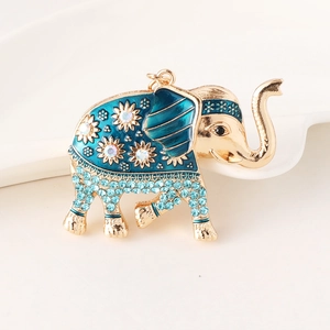 Golden elephant keychain with blue enamel and sparkling crystal floral patterns