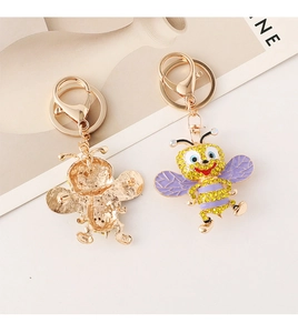 Macro detail of bee keychain with yellow and purple rhinestones and dual-use pin back