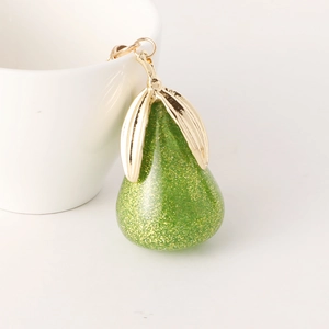 Porte-clés créatif en forme de poire en résine verte avec paillettes dorées sur tasse