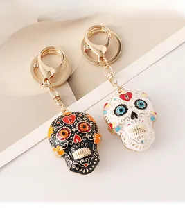 Detail of colorful mandala skull keychains with heart patterns in black and white enamel