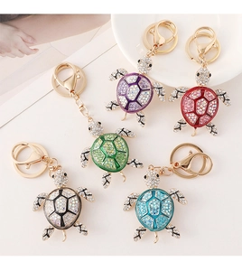 Detailed close-up of colorful rhinestone-encrusted sea turtle keychains in five vibrant colors