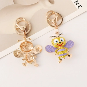 Sparkling rhinestone honey bee keychain and brooch with yellow crystals and purple enamel
