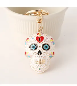 Macro view of Sugar Skull keychain with colorful enamel floral details and gold clasp