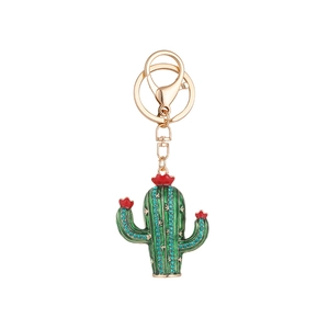 Green cactus keychain with blue rhinestones and gold lobster clasp on white background