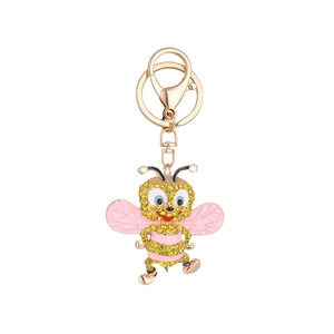 Sparkling crystal bee keychain with gold plating and pink wings on a white background