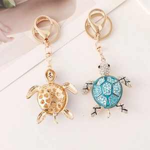 Creative turtle keychains with golden hollow heart design and blue crystal rhinestones