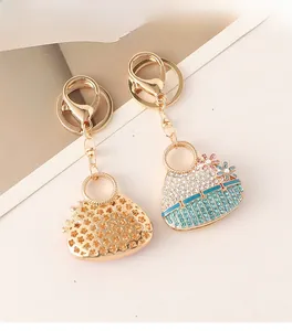 Detailed close-up of crystal-encrusted flower handbag keychain with secure lobster clasp