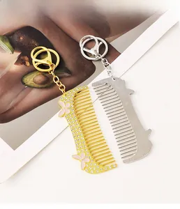Detail of rhinestone hair comb keychains in gold and silver with butterfly charms