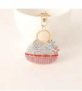 Macro view of handbag keychain with pink rhinestones and flower charm details