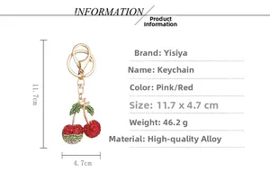 Detailed view of rhinestone cherry keychain size 11.7x4.7cm with golden alloy lobster clasp