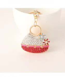 Close-up of a sparkling flower handbag keychain with red and white rhinestones