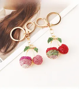 Detailed view of luxury cherry keychains with sparkling rhinestones in pink and red