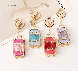 Close-up of sparkling rhinestone suitcase keychains in multiple vibrant colors