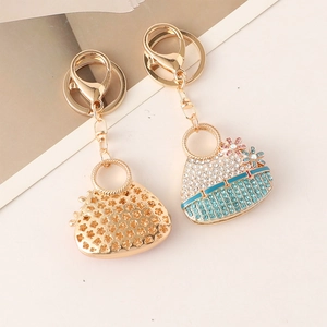 Creative floral purse keychain with sparkling rhinestones and hollow metal design