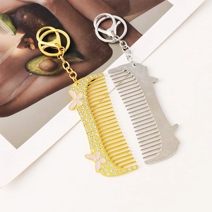 Fashionable diamond-encrusted comb keychain set in gold and silver with lobster clasp