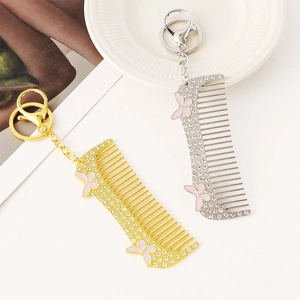 Exquisite rhinestone-studded comb keychains with pink butterfly designs in gold and silver