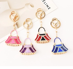 Detailed set of four crystal rhinestone handbag keychains in gold-plated alloy