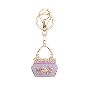 Elegante paarse handtas sleutelhanger met glanzende steentjes en gouden sluiting