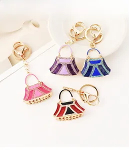 Detail view of colorful rhinestone handbag keychains in pink blue and purple colors