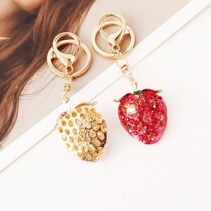 Cute strawberry keychains set with golden hollow and red rhinestone designs