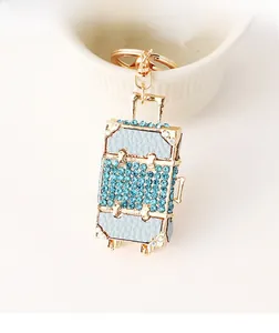 Detail of light blue rhinestone suitcase keychain with gold alloy lobster clasp