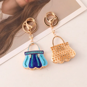 Detail of blue enamel handbag keychain with gold plating and sparkling crystals