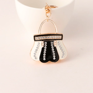 Macro shot of black and white enamel handbag keychain with sparkling rhinestones