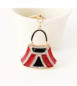 Detailed close-up of a luxury red and black handbag keychain with sparkling rhinestones