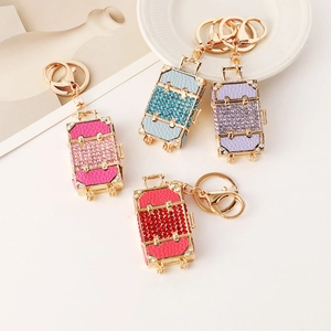 Creative mini suitcase keychains with sparkling rhinestones in four vibrant colors
