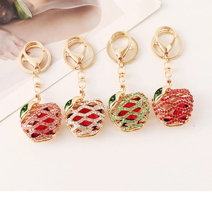 Macro detail of apple-shaped keychains with colorful rhinestones and gold alloy base