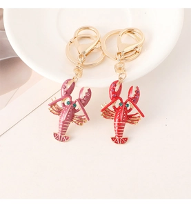 Detailed close-up of red enamel lobster keychains with gold plating and crystals
