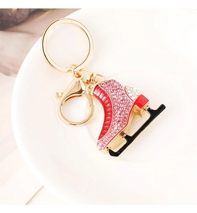 Detailed close-up of a crystal-studded ice skate keychain with pink rhinestones