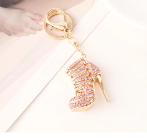 Macro detail of sparkling pink rhinestone high heel keychain with golden alloy lobster clasp
