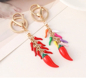 Detailed macro of golden keychain hooks with colorful chili pepper cluster charms
