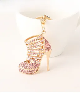 Detailed macro view of gold-tone high heel keychain with sparkling pink rhinestones