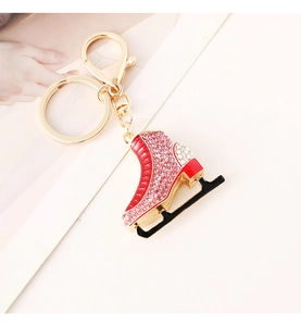Close-up of red rhinestone ice skate keychain with sparkling crystals and golden metal ring