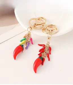 Detail of red and multi-color pepper charms with gold-plated keychain rings and clasps